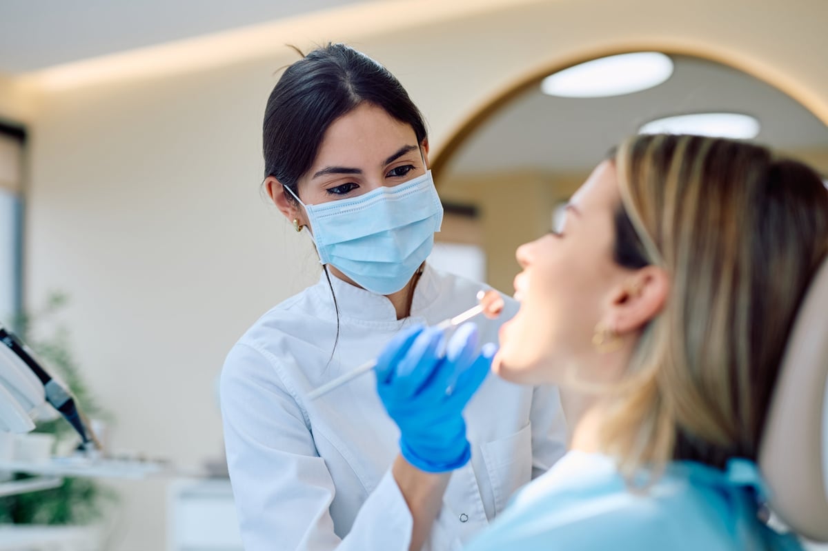 Female dentist performing an oral examination in a modern dental clinic